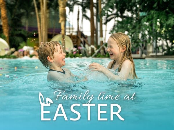 Two children are swimming in a palm-tree paradise