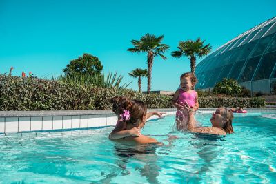 Eine Familie planscht im Außenpool