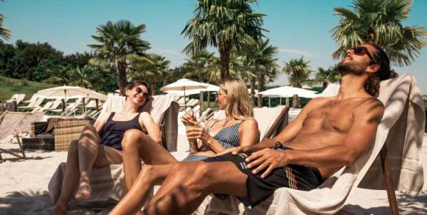 A group is sitting outside on chairs at Paradise Beach